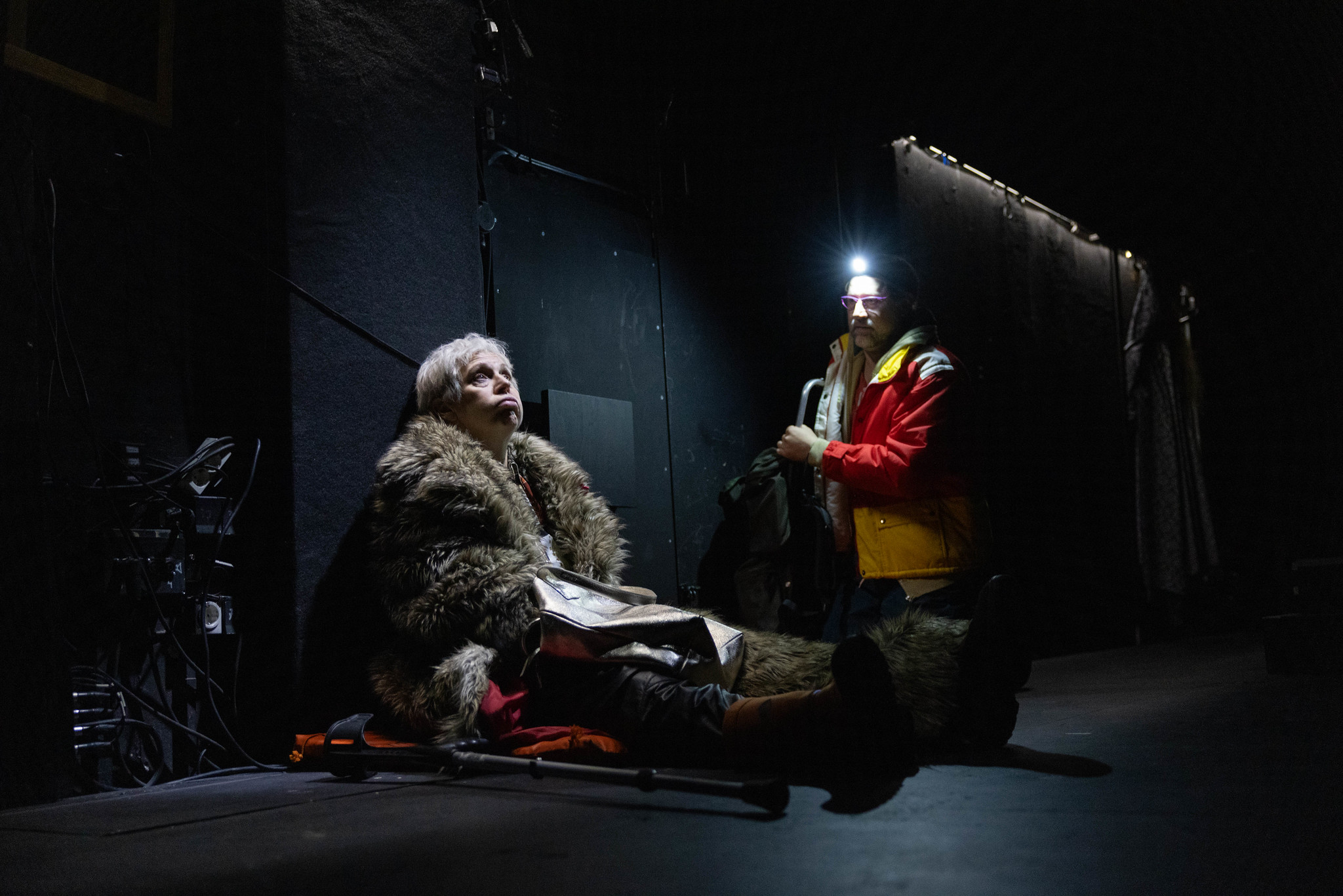 Mari Turunen and Lari Halme sit on the floor backstage.