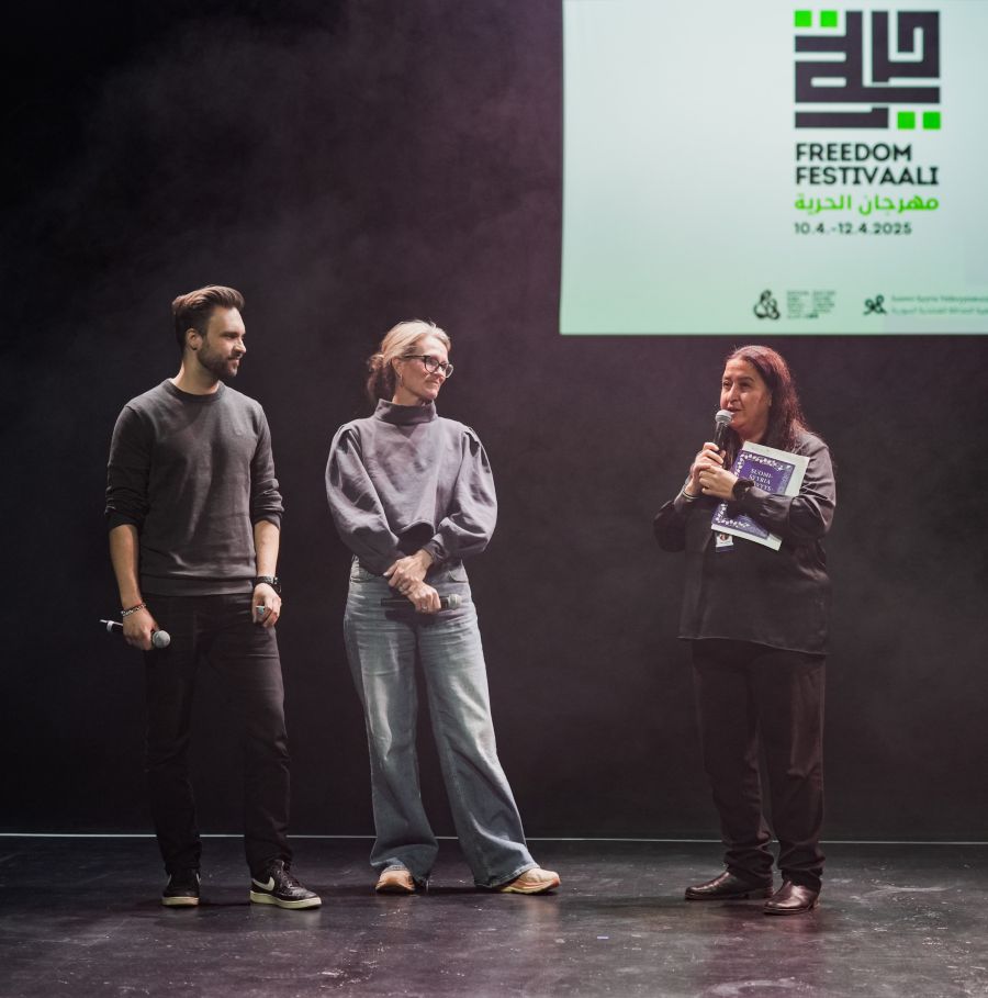 Three people on stage.